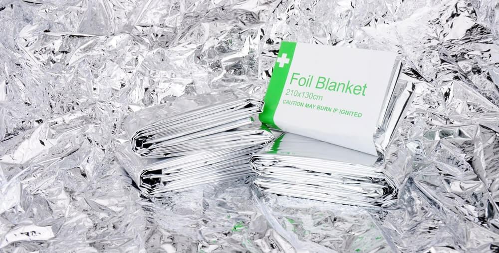 Emergency foil space blankets with a foil backgroun